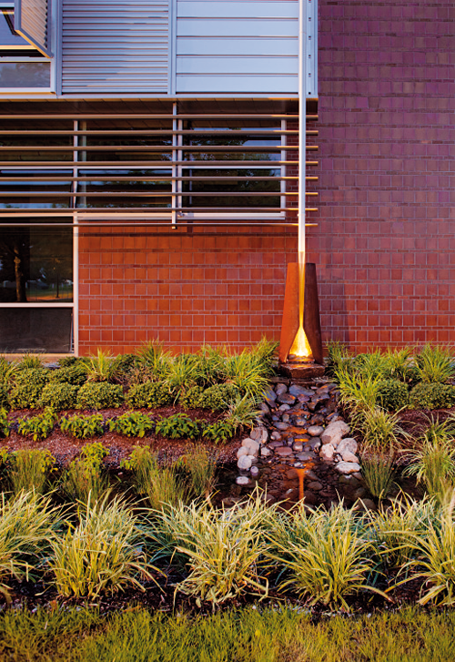 Close up of exterior siding, planting and drainspout at Chemeteka Comm College