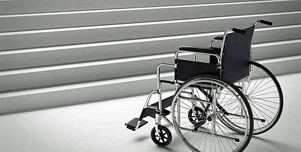 empty wheelchair facing stairs