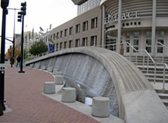 A waterwall structure and bollards at the terminus of a