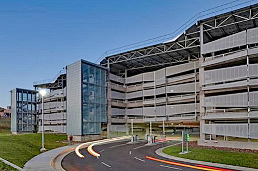 NREL garage at the US Department of Energy Laboratory includes a state of the art solar array. It is exposed structural and architectural steel including a center light well for natural daylighting.
